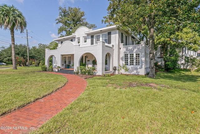 mediterranean / spanish-style home with a front lawn