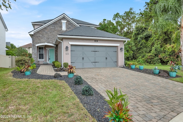 view of front of home featuring a front lawn and a garage