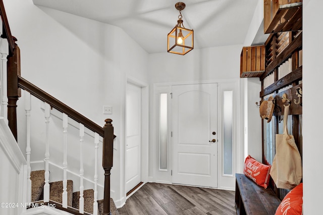 foyer entrance featuring stairway and wood finished floors