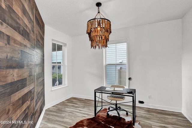 office with a notable chandelier, wood finished floors, and baseboards