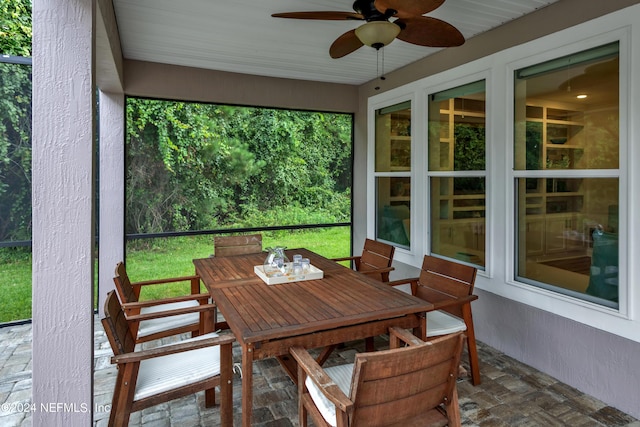 sunroom featuring a healthy amount of sunlight and ceiling fan