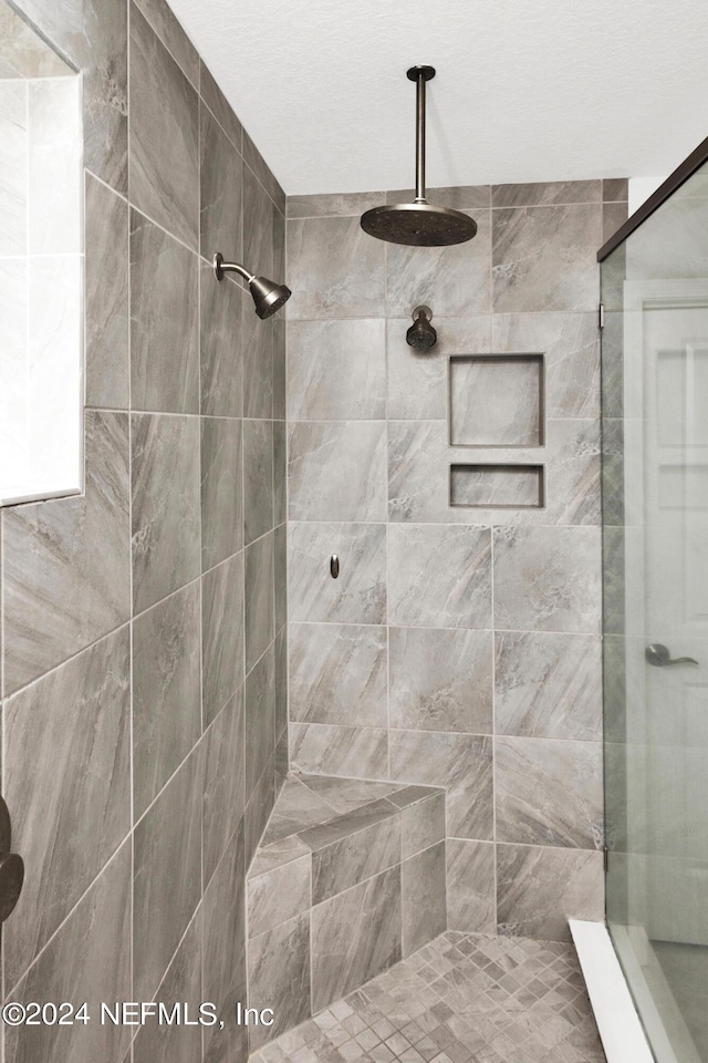 full bathroom with a tile shower