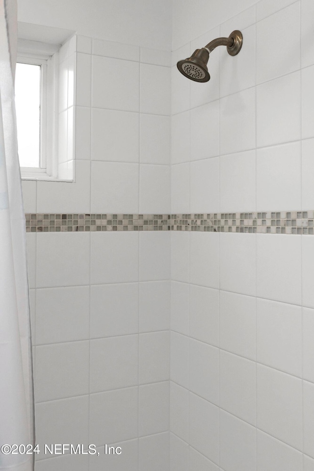 full bath with a tile shower