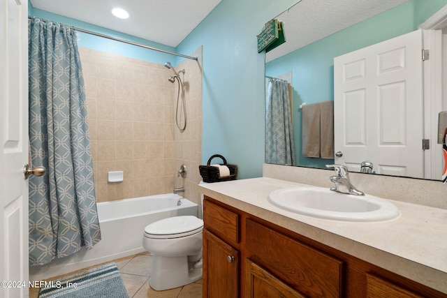 full bathroom with shower / bath combination with curtain, tile patterned floors, a textured ceiling, vanity, and toilet