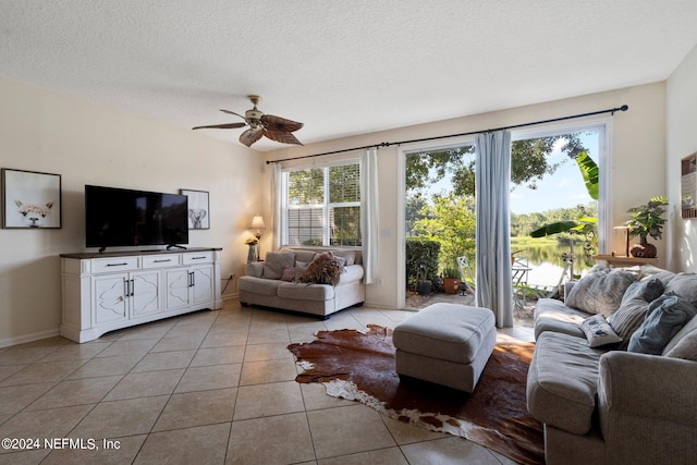 tiled living room featuring ceiling fan and a textured ceiling