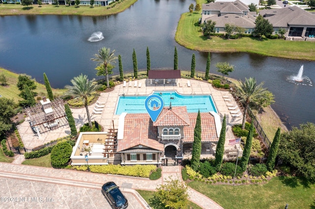 view of swimming pool with a water view and a patio