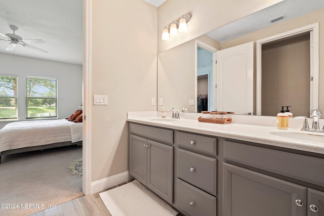 bathroom featuring ceiling fan and double vanity