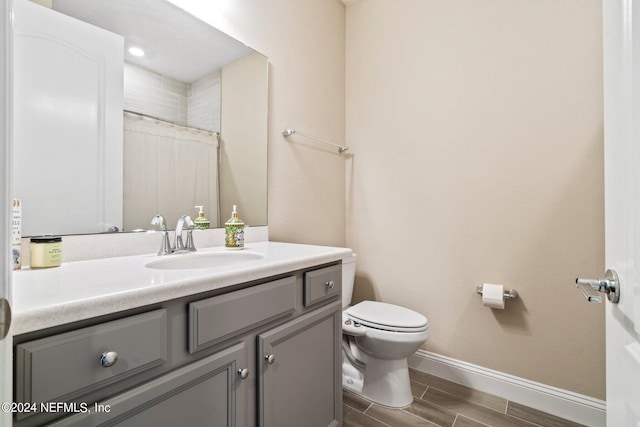 bathroom featuring toilet and vanity