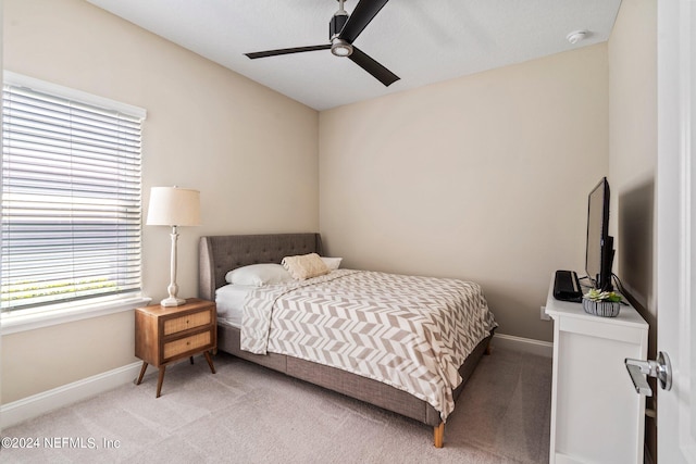 bedroom featuring ceiling fan and light carpet