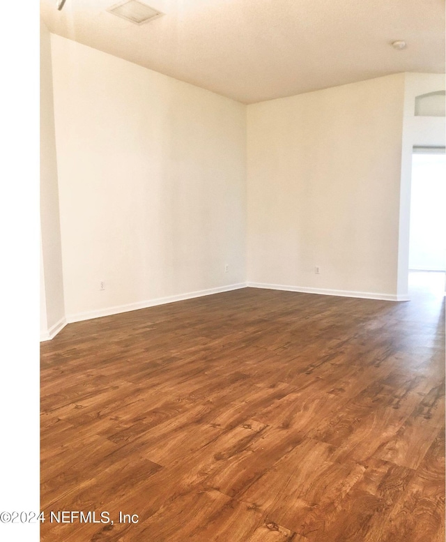 empty room featuring dark hardwood / wood-style flooring