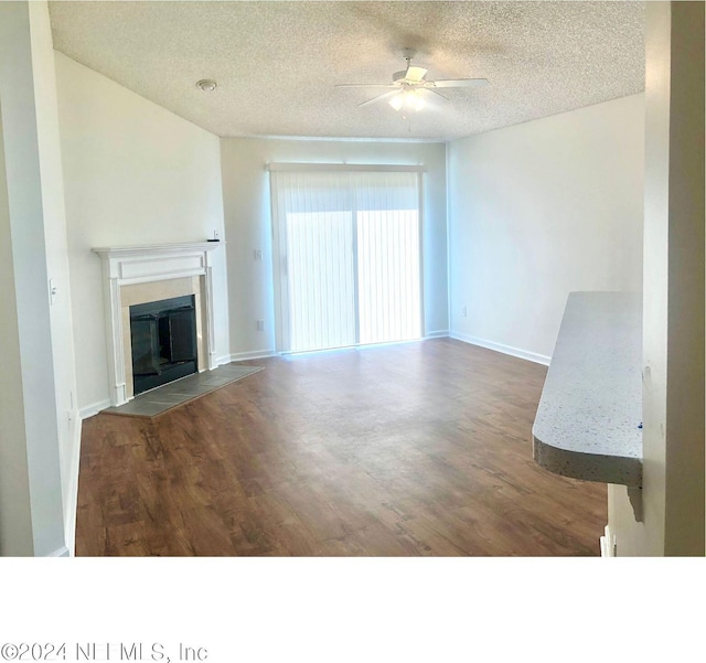 unfurnished living room featuring a textured ceiling, ceiling fan, and hardwood / wood-style flooring