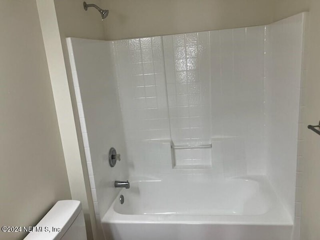 bathroom featuring toilet and tub / shower combination