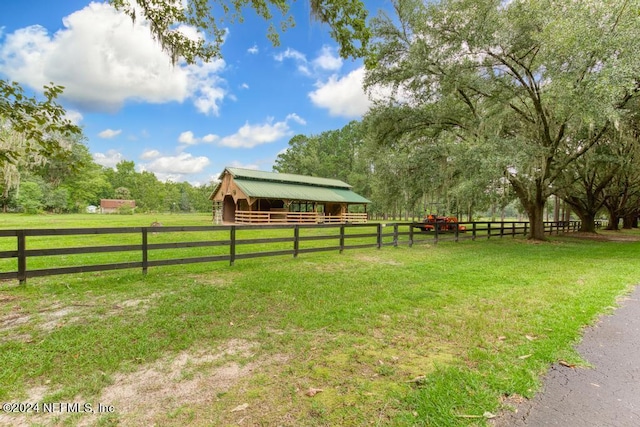 view of yard with an exterior structure, an outdoor structure, and a rural view
