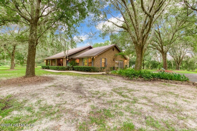 view of side of property with a yard