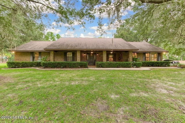 ranch-style house with a front lawn