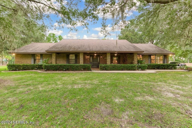 single story home with brick siding and a front lawn