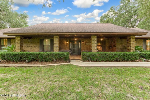 single story home featuring a front lawn, a porch, and brick siding