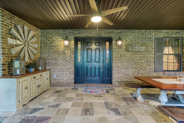 entrance to property with a ceiling fan