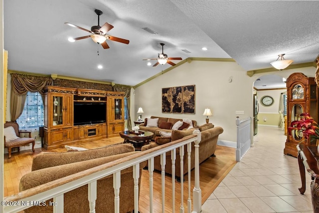 living room with vaulted ceiling, light hardwood / wood-style floors, and ornamental molding