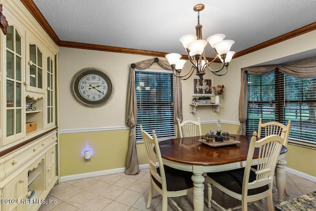 tiled dining area with an inviting chandelier, a textured ceiling, and ornamental molding