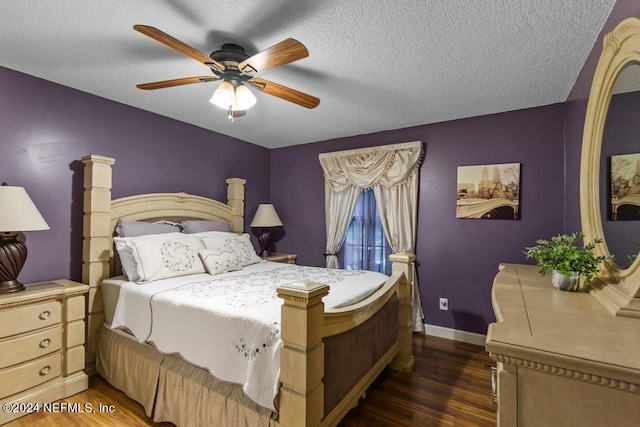 bedroom with ceiling fan, dark hardwood / wood-style floors, and a textured ceiling