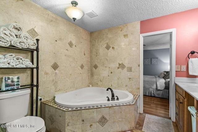 bathroom featuring a textured ceiling, tiled bath, hardwood / wood-style floors, tile walls, and toilet