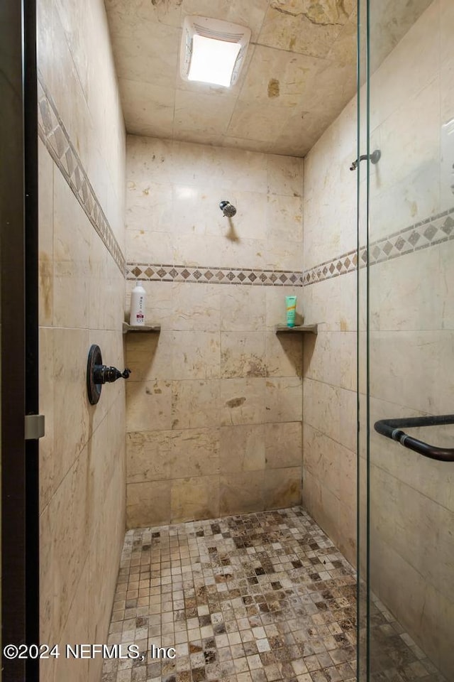 bathroom with a shower with shower door