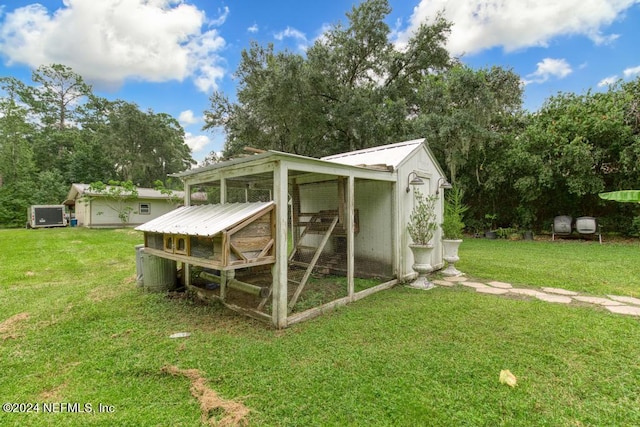 view of outbuilding with a lawn