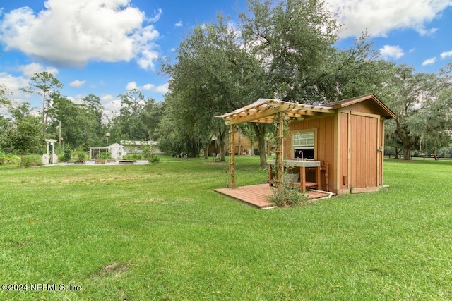 view of yard featuring a pergola and an outdoor structure