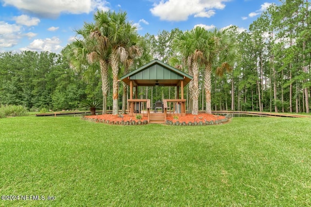 view of yard featuring a gazebo, a deck, and ceiling fan