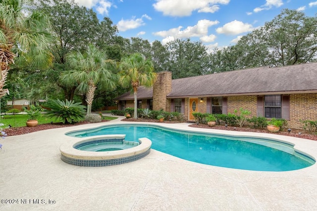 view of pool featuring a pool with connected hot tub