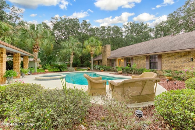 view of swimming pool with a patio area and an in ground hot tub