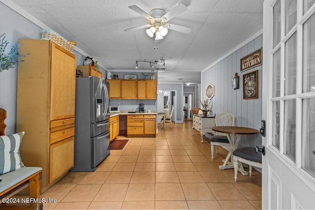 kitchen with a textured ceiling, light countertops, a ceiling fan, stainless steel fridge with ice dispenser, and light tile patterned floors