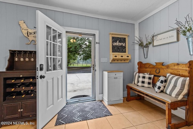 doorway to outside featuring light tile patterned flooring