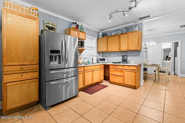 kitchen featuring light tile patterned floors, crown molding, a chandelier, track lighting, and stainless steel refrigerator with ice dispenser