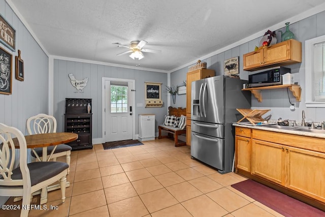 kitchen with crown molding, stainless steel appliances, sink, ceiling fan, and light tile patterned flooring