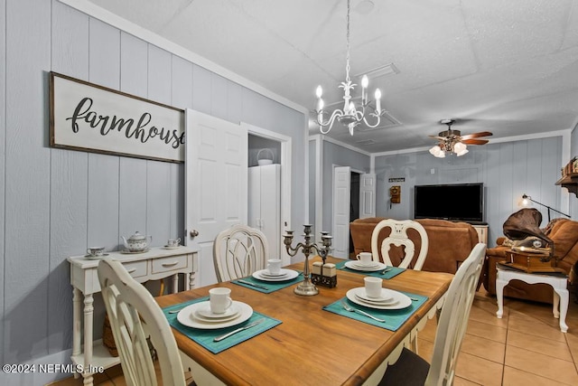 tiled dining space with ceiling fan with notable chandelier and crown molding