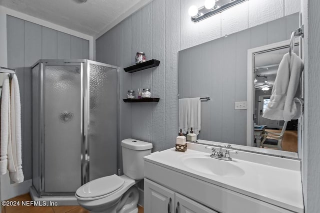 full bath featuring toilet, vanity, and a stall shower