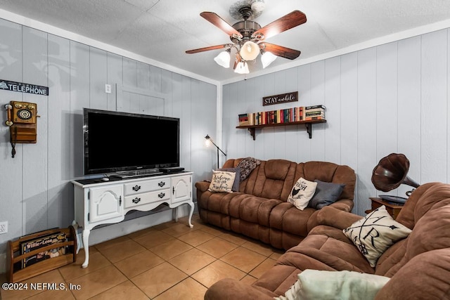 tiled living room featuring wood walls and ceiling fan