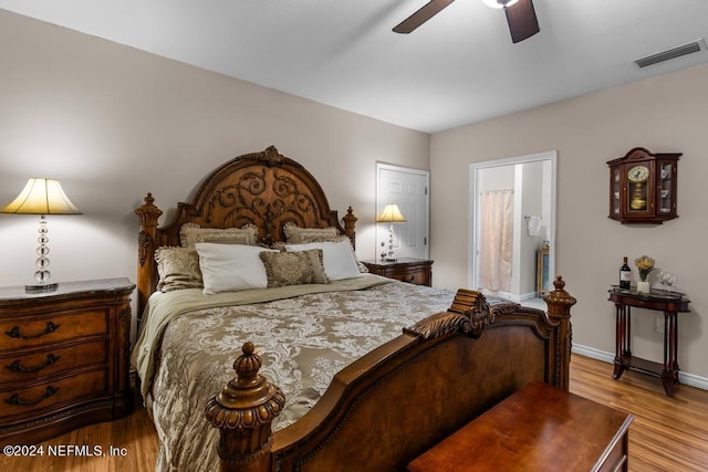 bedroom with visible vents, baseboards, connected bathroom, ceiling fan, and wood finished floors