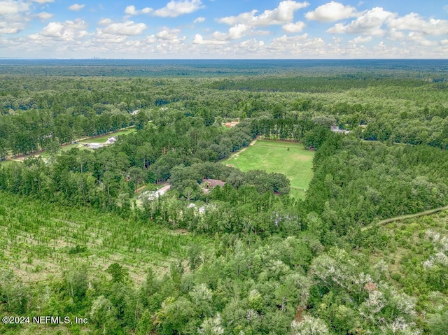 birds eye view of property featuring a forest view
