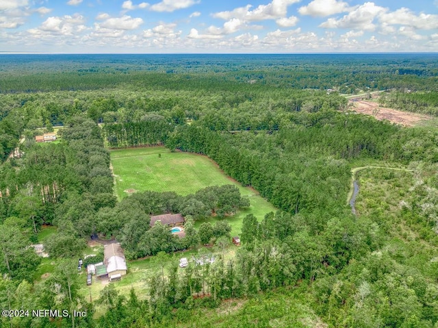drone / aerial view featuring a view of trees