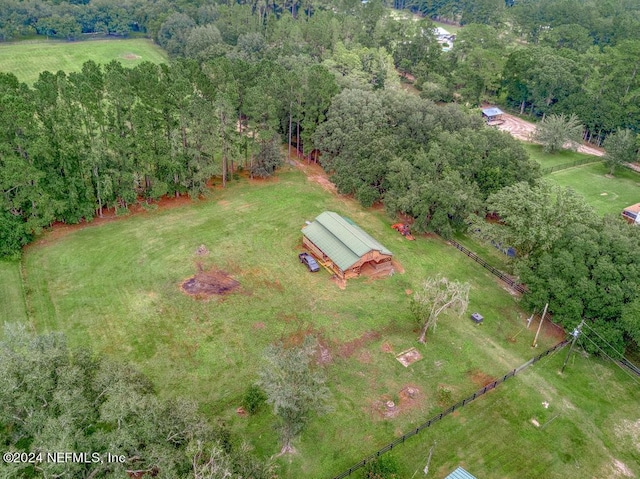 drone / aerial view featuring a wooded view