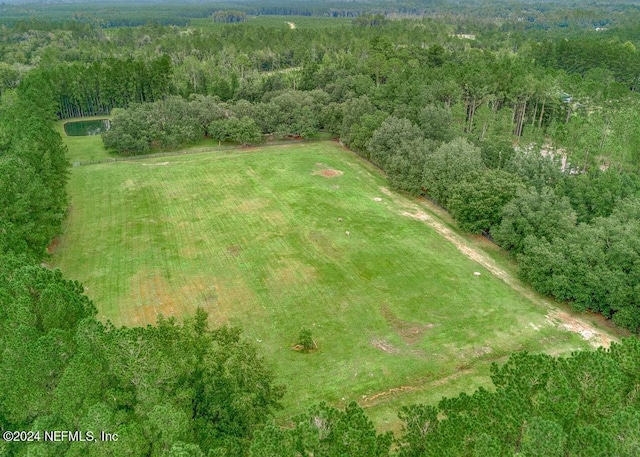 drone / aerial view featuring a forest view