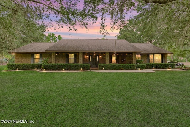 ranch-style home with a lawn