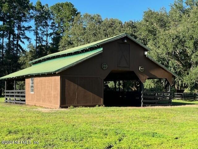 exterior space with a yard and an outbuilding