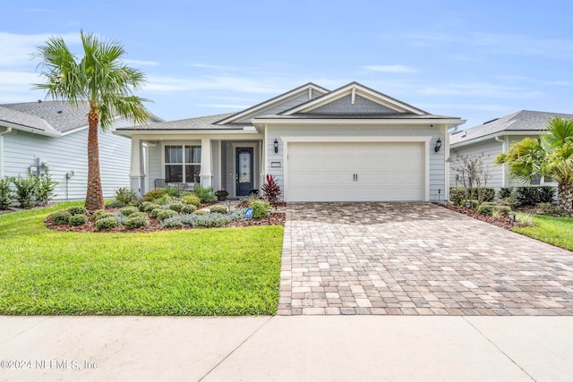 view of front of house with a front yard and a garage