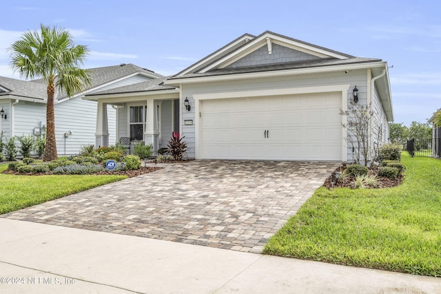 view of front facade with a front yard and a garage