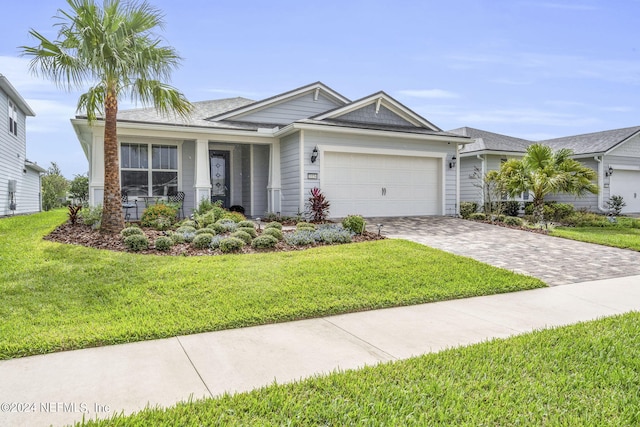 view of front of property featuring a garage and a front yard