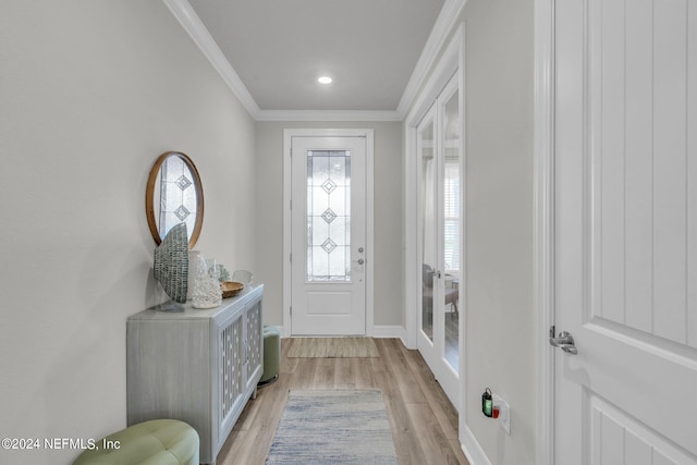 entrance foyer featuring ornamental molding and light hardwood / wood-style floors